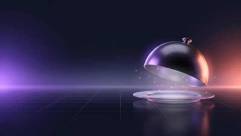 Campânula de metal levantada sobre um prato de vidro, com pequenas faíscas de luz.